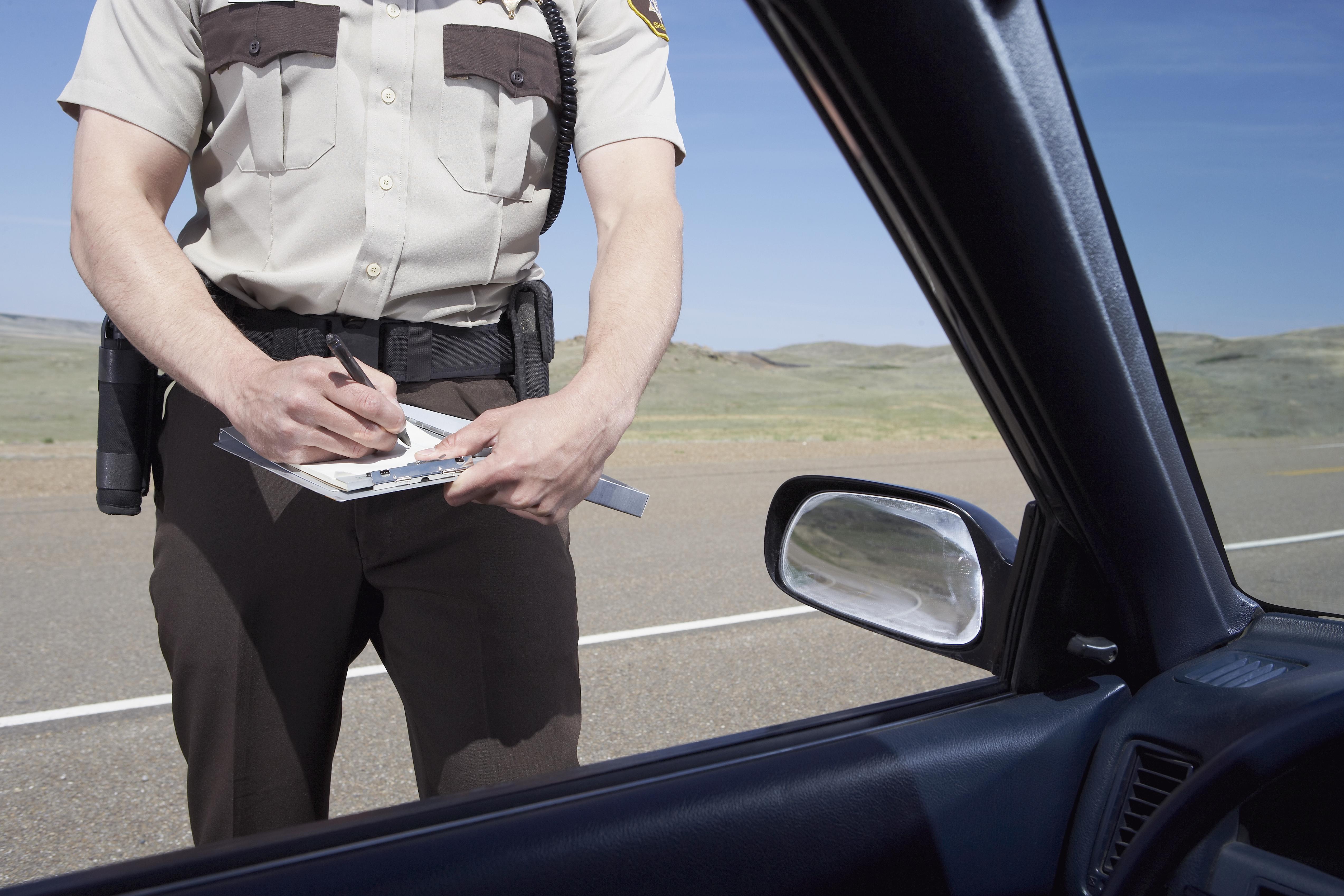 highway patrolman writing ticket