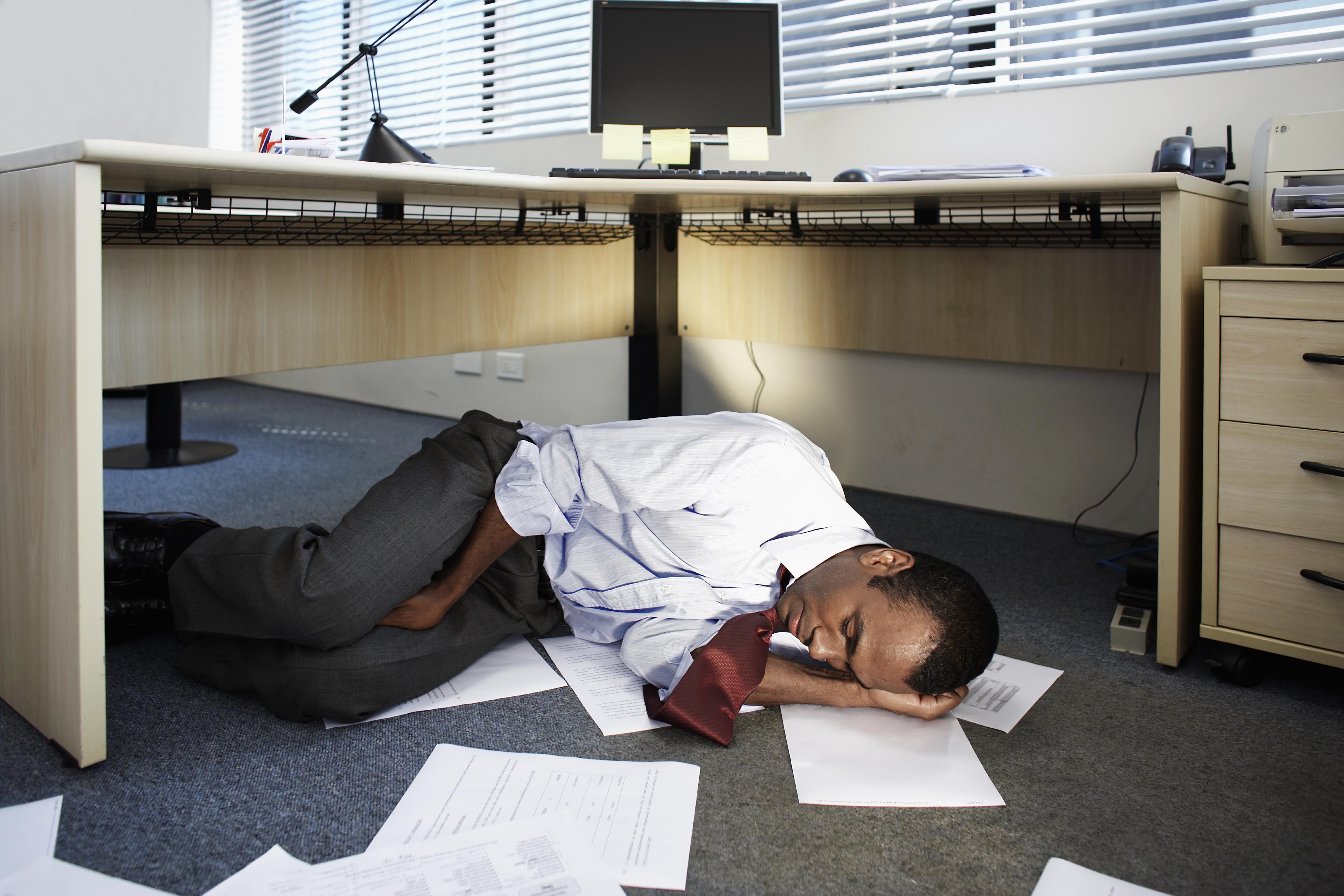 Mid Adult Man Sleeping Near Documents on Floor