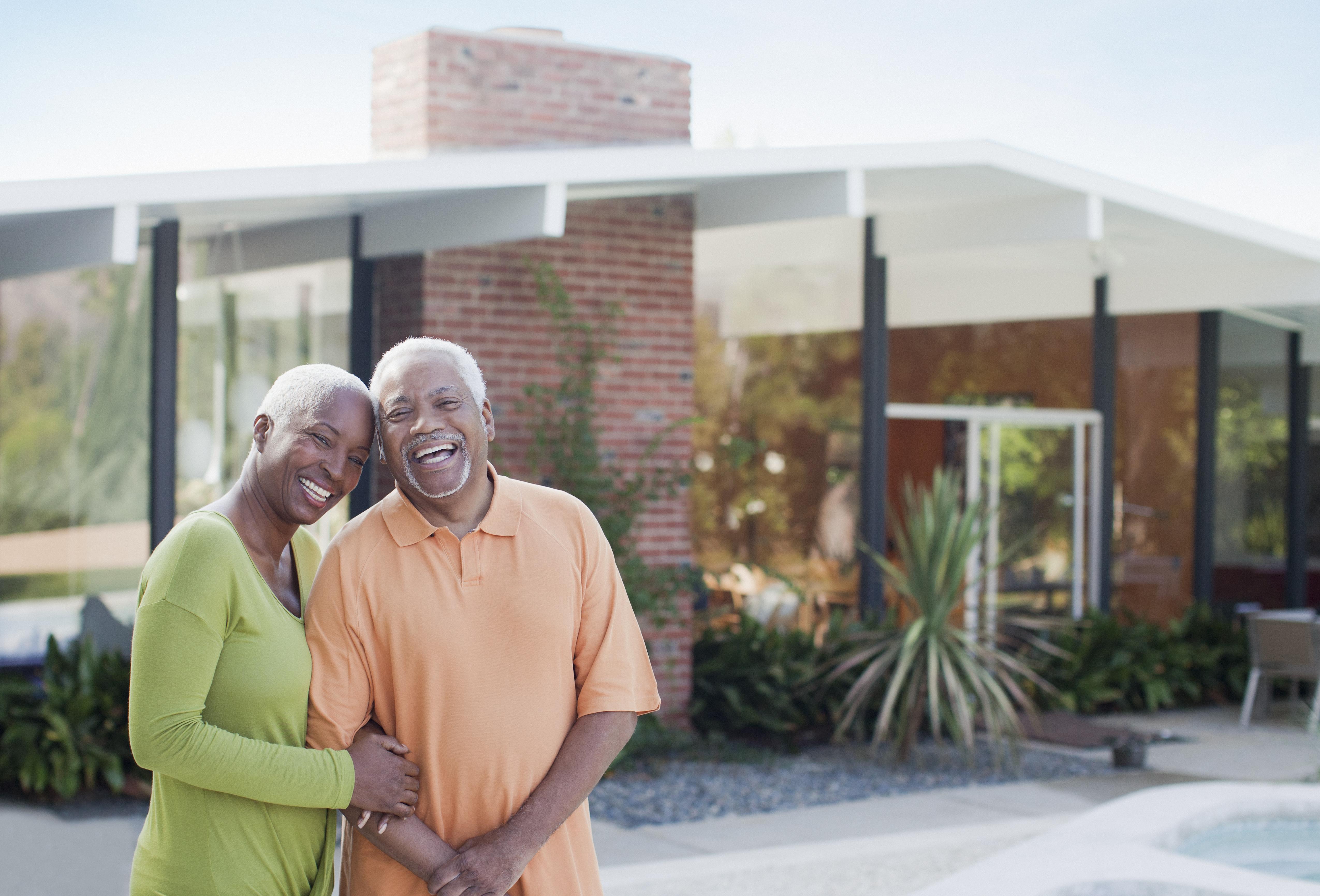 Older couple smiling in backyard