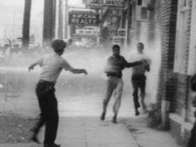 B/W 1963 authorities hosing demonstrators on sidewalk in civil rights riot / Alabama / newsreel