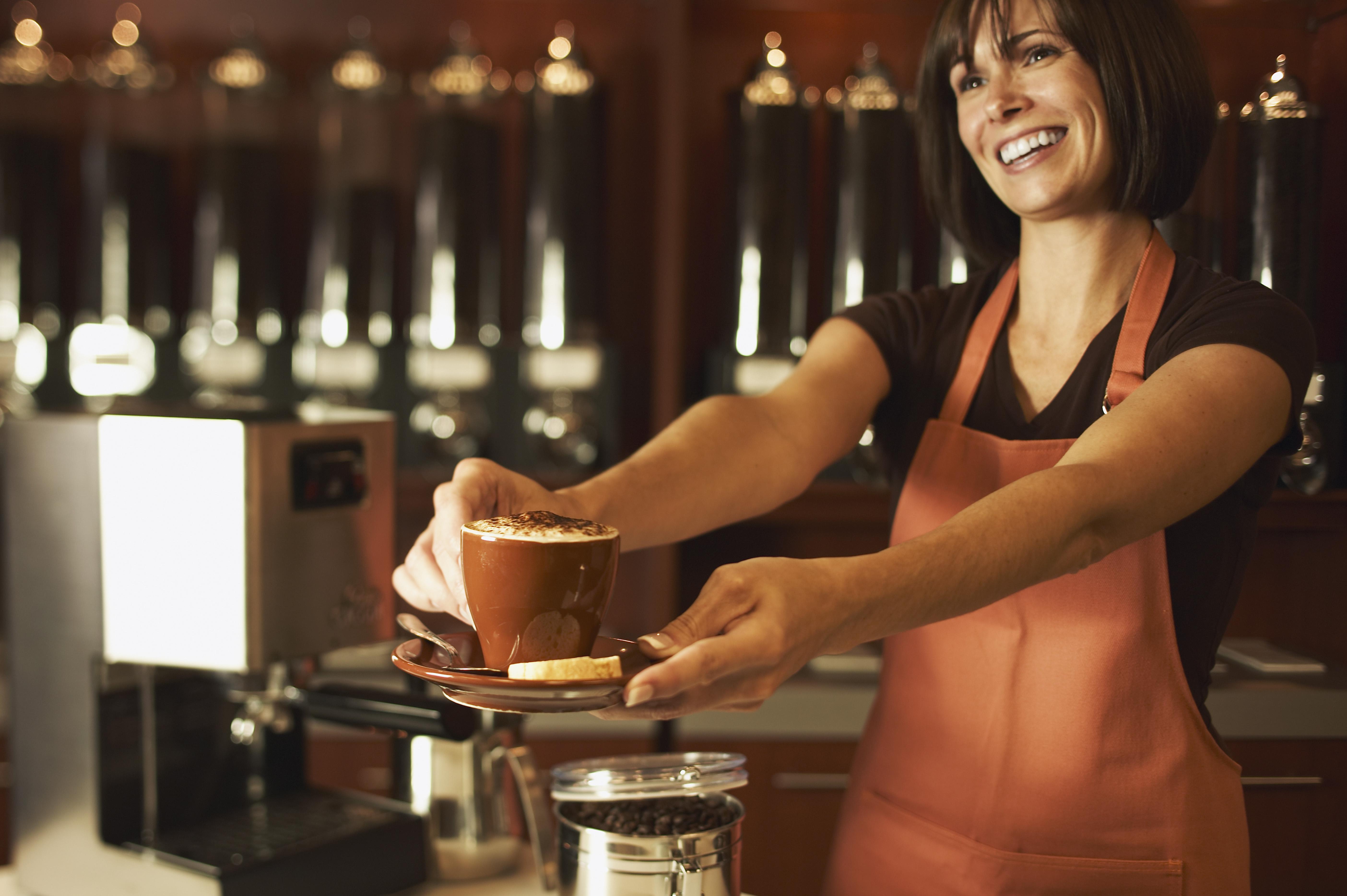Clerk presenting cappuccino