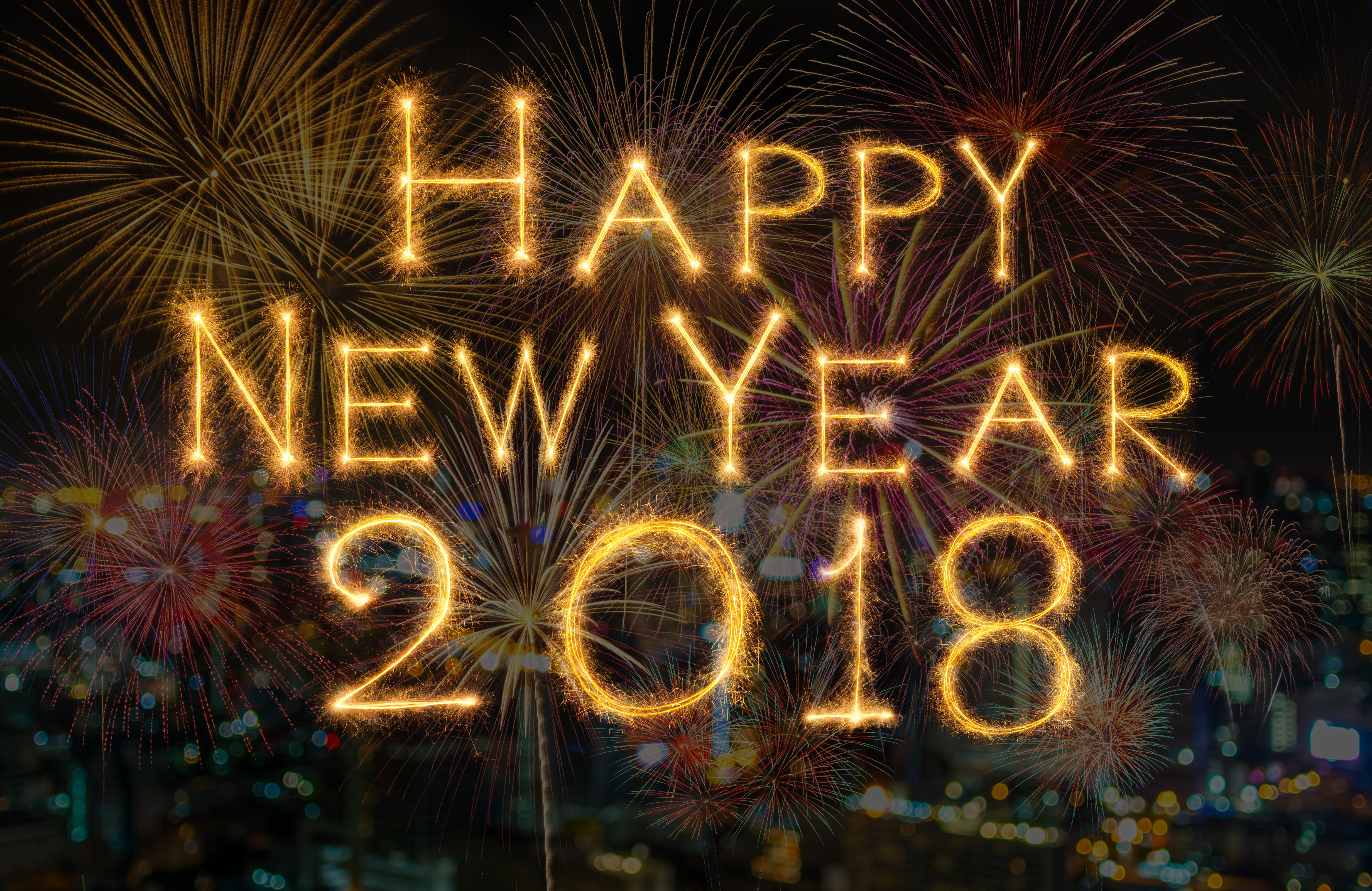 celebration and greeting cards concept, Happy new year 2018 written with Sparkle firework on fireworks with dark background