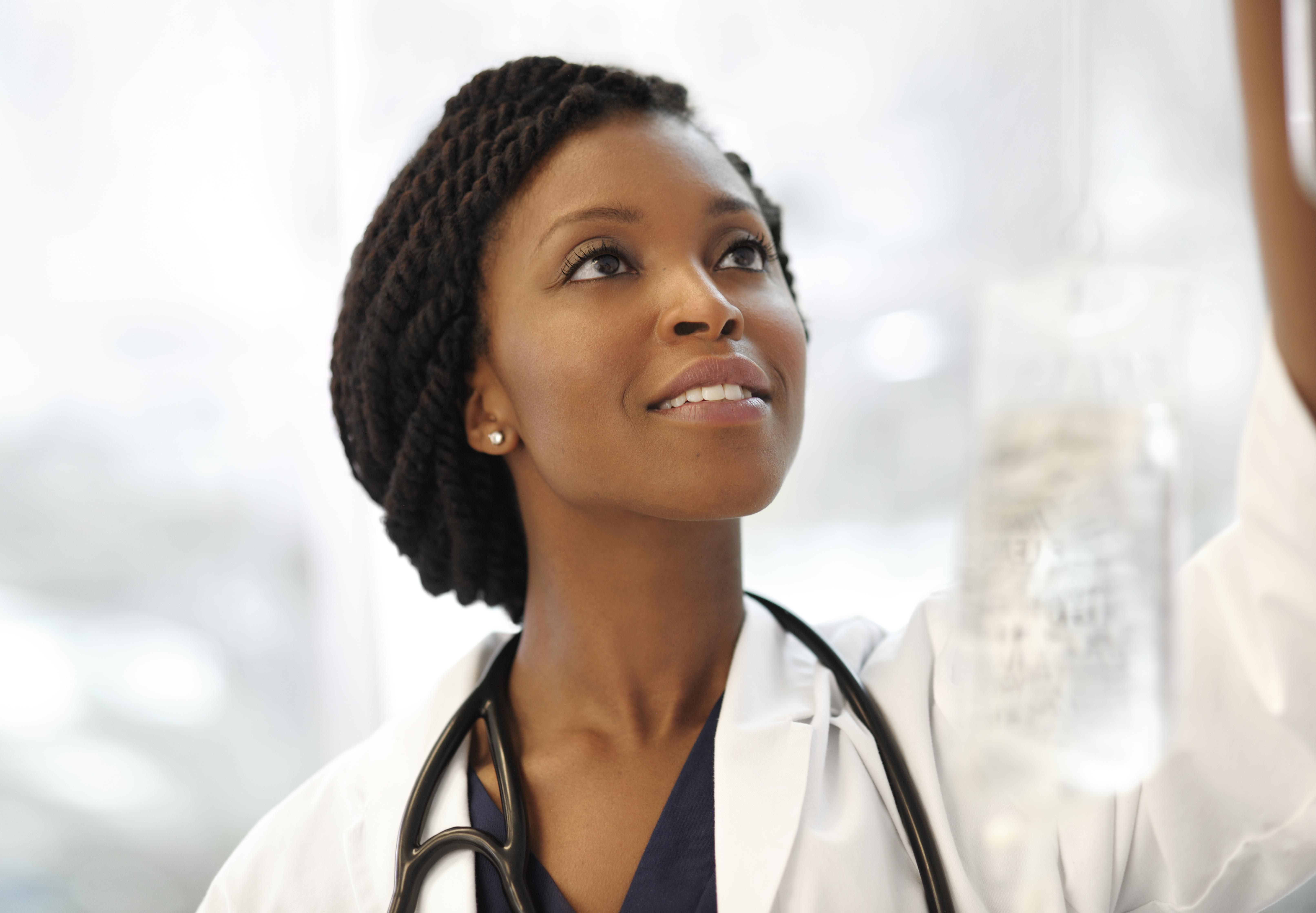 Beautiful ethnic doctor with intravenous
