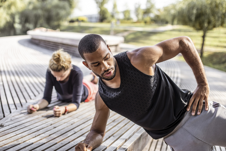 Young Multi Ethnic Couple Exercising in Public Park