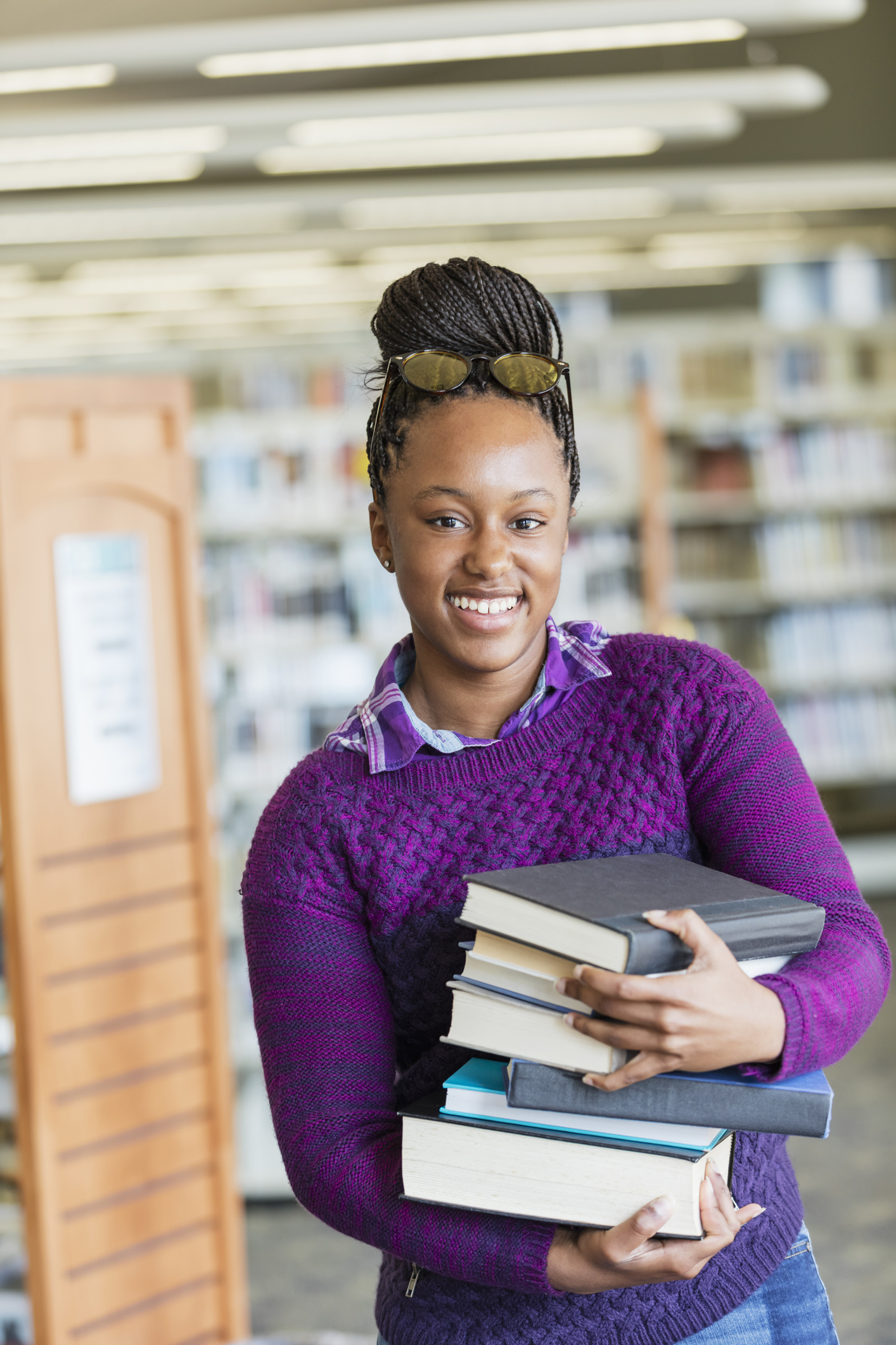 African-American high school student with stack of books