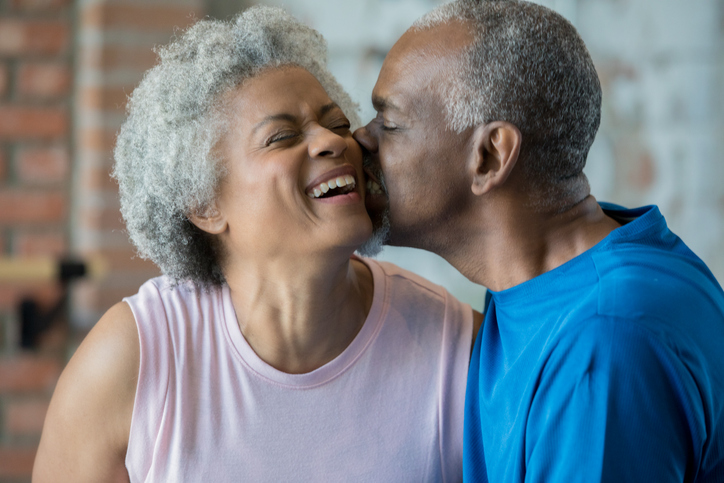 Senior man kisses wife on cheek