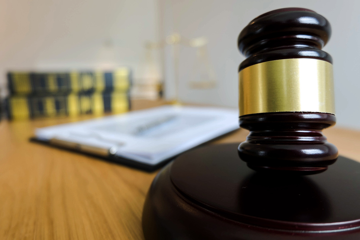 Close-Up Of Mallet And Gavel On Desk