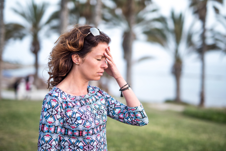 Mature woman having a strong headache.