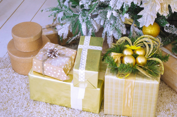 Close-Up Of Christmas Presents By Tree On Floor