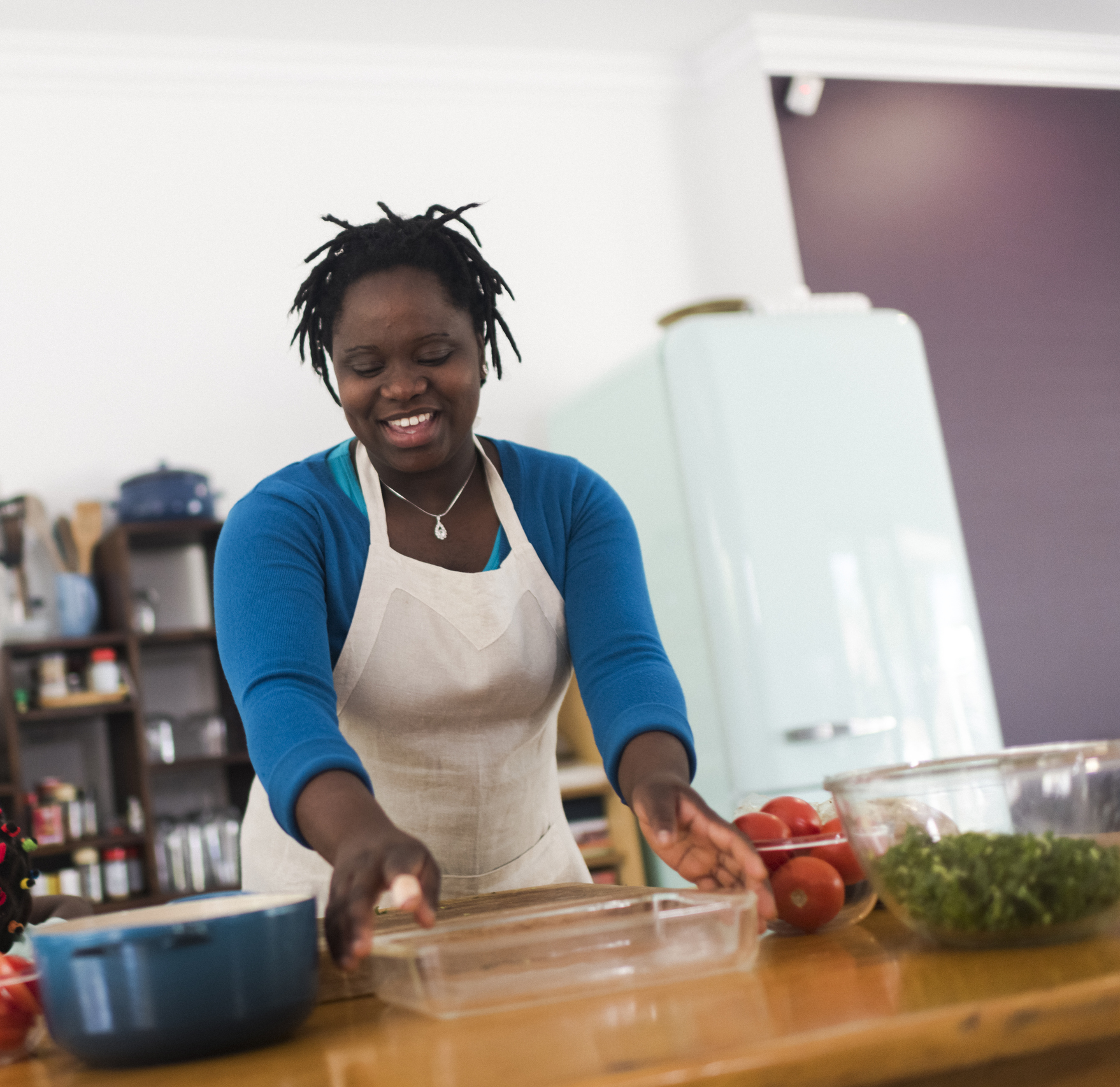 Low angle view of a smiling mother preparing a meal in her kitchen