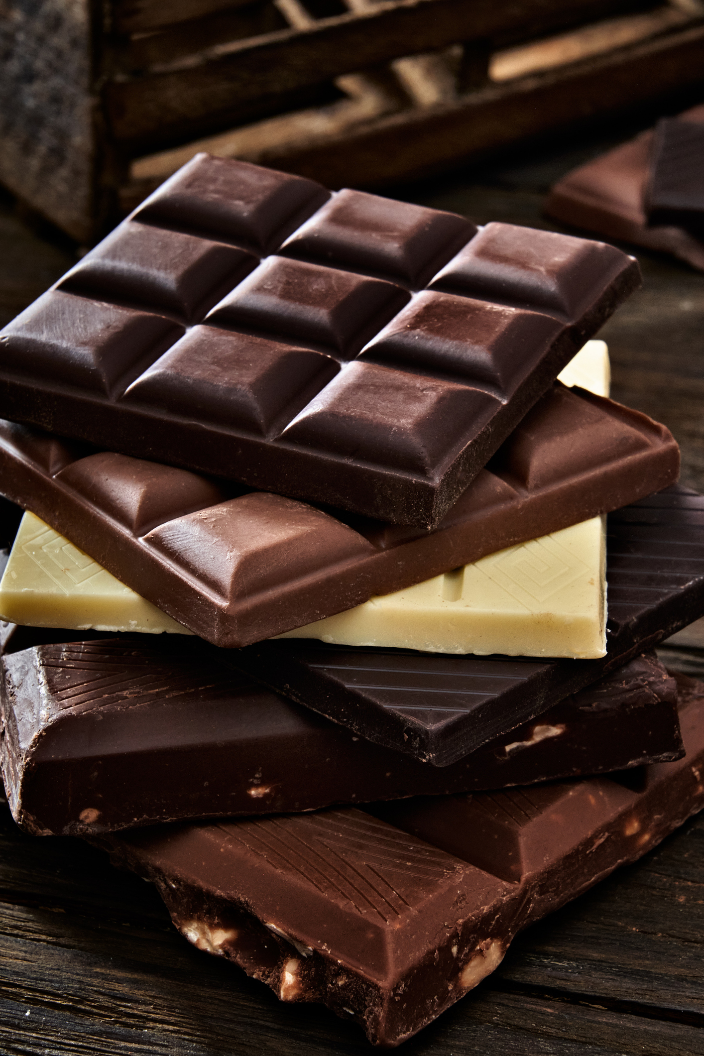 Chocolate bars in rustic wooden table