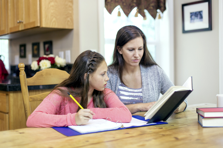 Mother helping daughter with her homework
